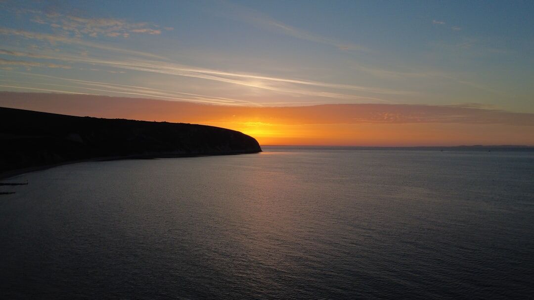 Moody coastal cliff sunset photograph
